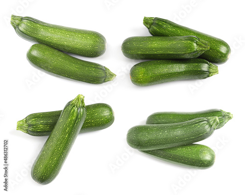 Set of fresh ripe zucchinis on white background, top view