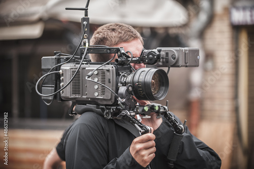 Obraz na płótnie Behind the scene. Cameraman shooting film scene with his camera