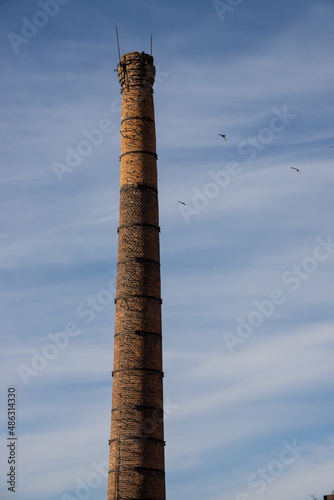 old factory or enterprise brick chimney reaching for the sky