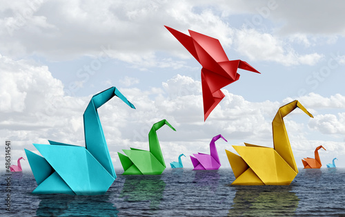 Changing your life concept and fearless courage symbol as diverse origami swans floating on water with a confident bird rising up and flying away as business confidence or fearlessness photo