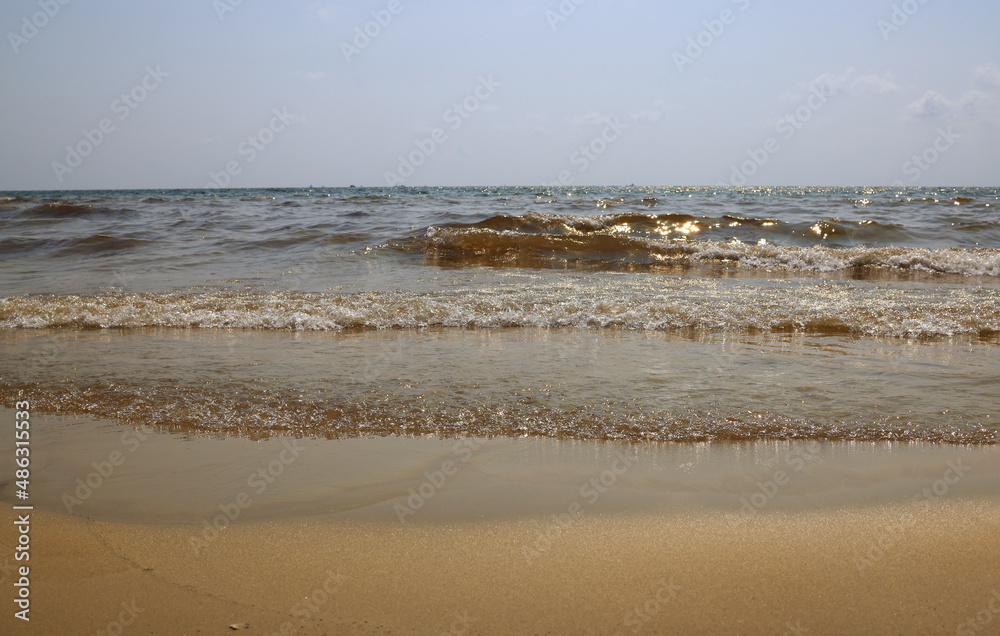The sea and the beach are polluted with oil. A crude oil spill on the sand of a city beach