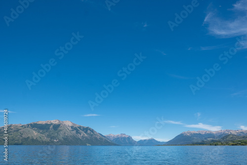 View of the Lake in the mountains in spring. Patagonian Coast Lake. Waves on the coast. Peninsula. Vertical Panoramic View. 