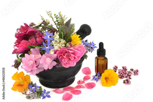 Flowers and herbs for herbal plant medicine treatments, seasoning and food decoration with essential oil bottle on white background. Alternative natural health and wellness concept.  photo