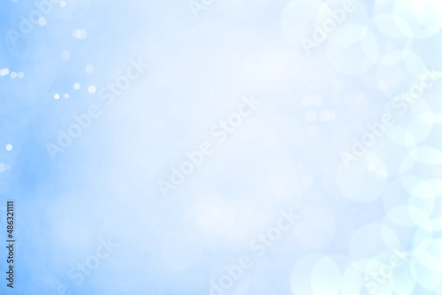 Vintage blurred bokeh with unfocused different lights on a pastel blue background