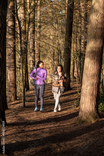 Young women walking in forest