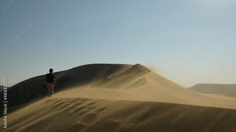 Man walking on sand due