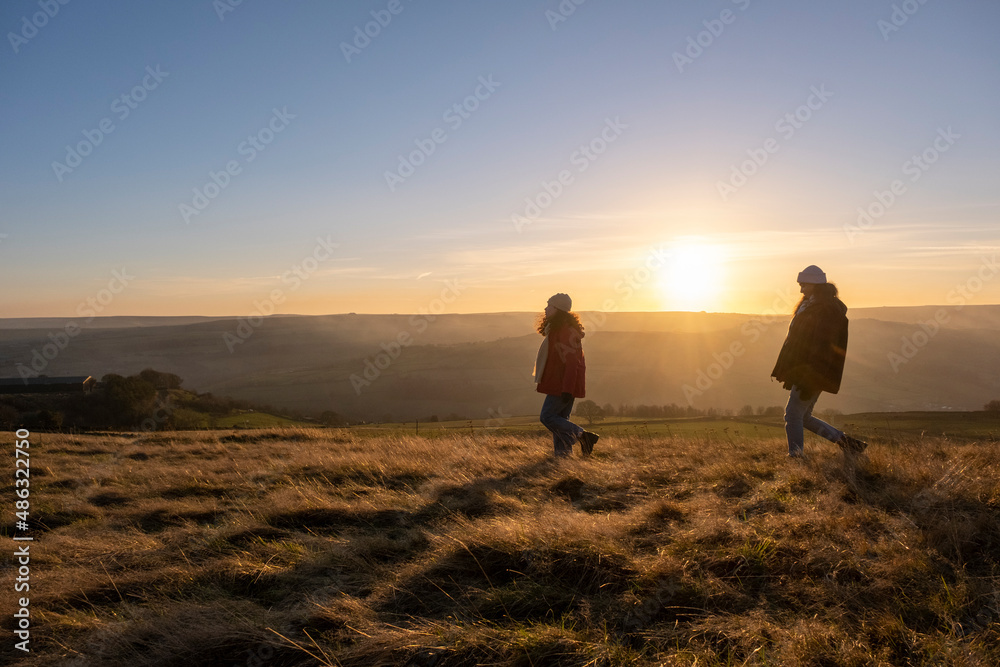 Young women hiking in rural landscape