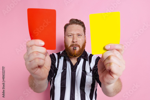 Comic portrait of sport referee wearing field judge uniform isolated on pink studio background. Concept of sport, rules, competitions, rights, ad, sales.