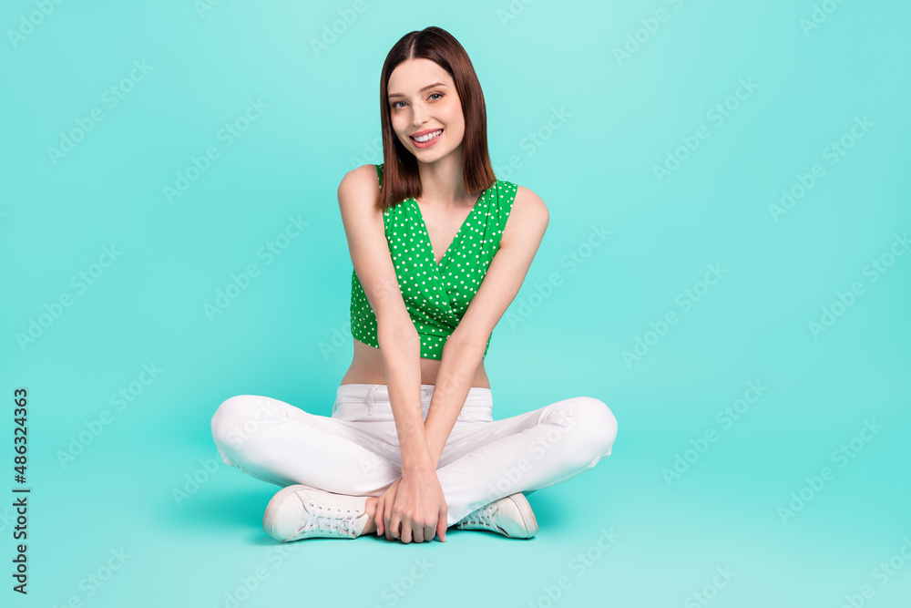 Full length photo of young adorable girl good mood relax free-time isolated over turquoise color background Full length photo of young adorable girl good mood relax free-time isolated over turquoise color background