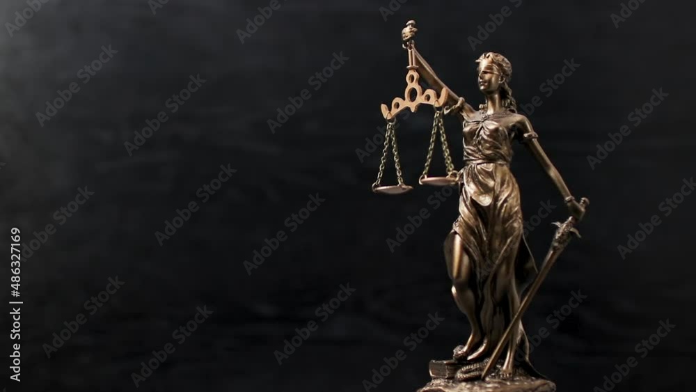 Bronze statue of themis or lady of justice on black background. Legal law.