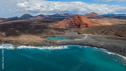 Charco Verde lake and volcan Bermeja on the island of Lanzarote, Spain