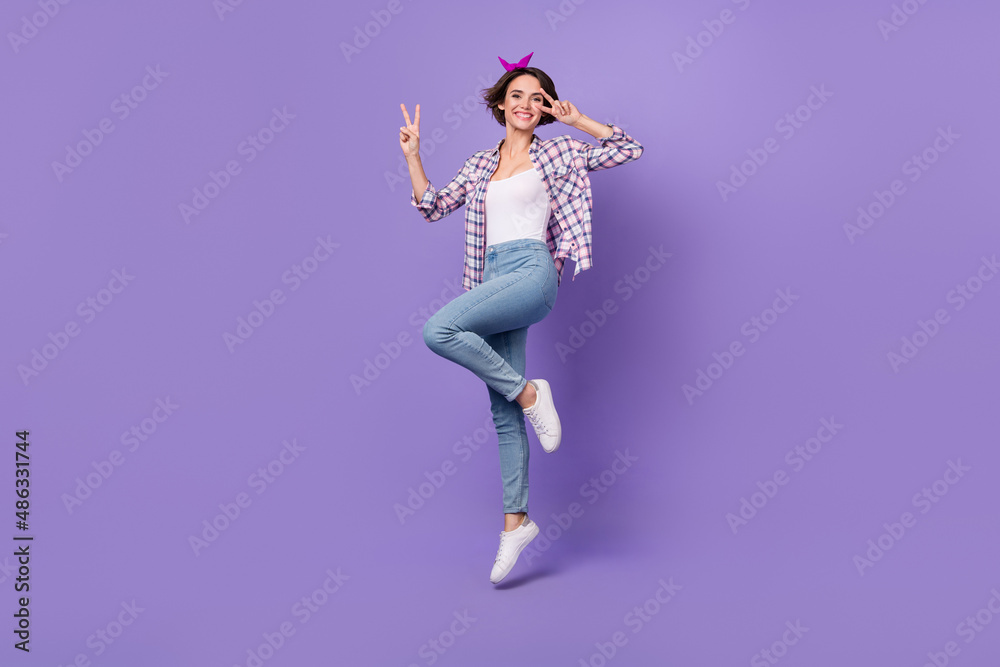 Photo of adorable cute woman wear plaid shirt jumping high v-sign cover eye isolated violet color background