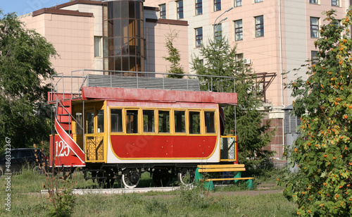 Kazan street in summer, Tatarstan, Russia - July 18 2021v- Retro tram. Place is tourist attraction of Kazan. Girl having fun with old vintage tramway. Transport, people travel and sightseeing concept.