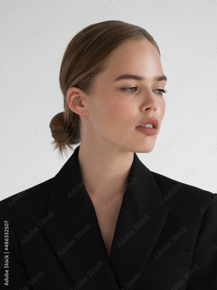 Natural look. Beauty model woman . Model test portrait with young beautiful fashion model posing on grey background. Blond woman in a black blazer . Natural makeup Natural look. Beauty model woman . Model test portrait with young beautiful fashion model posing on grey background. Blond woman in a black blazer . Natural makeup