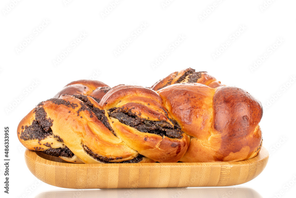 Two fragrant homemade poppy seed buns on a wooden tray, macro, isolated on a white background.
Two fragrant homemade poppy seed buns on a wooden tray, macro, isolated on a white background.