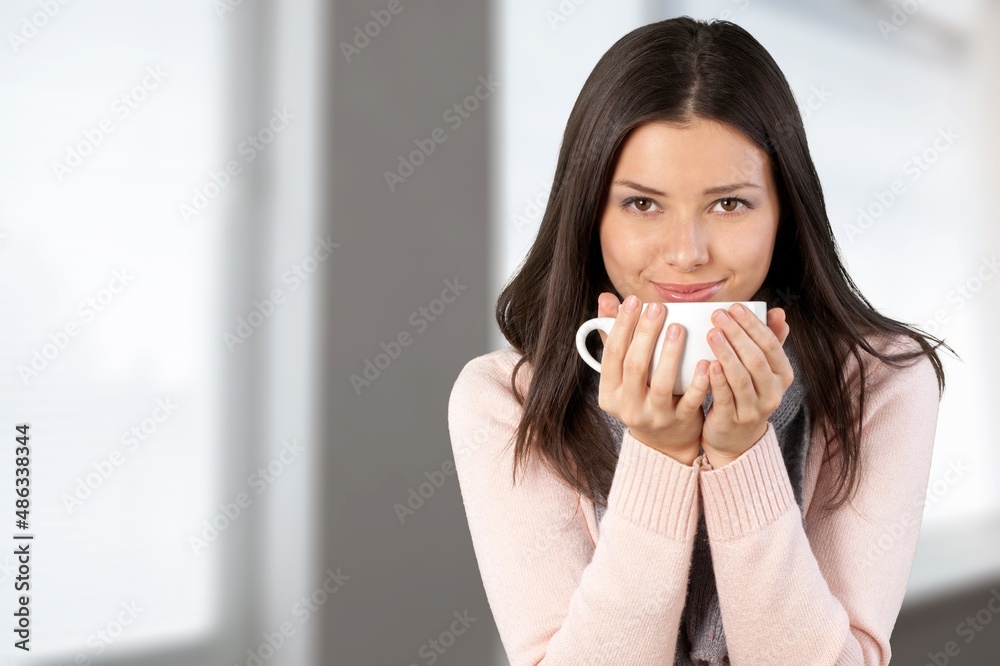 Portrait of beautiful woman relaxing with cup of hot drink. Lazy day off concept. Portrait of beautiful woman relaxing with cup of hot drink. Lazy day off concept.