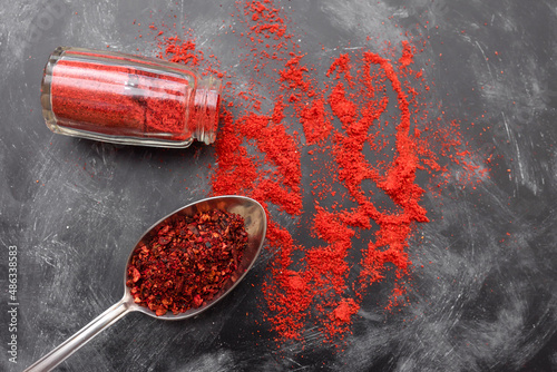 Fototapeta Naklejka Na Ścianę i Meble -  Paprika and tomato spice on the kitchen table, top view