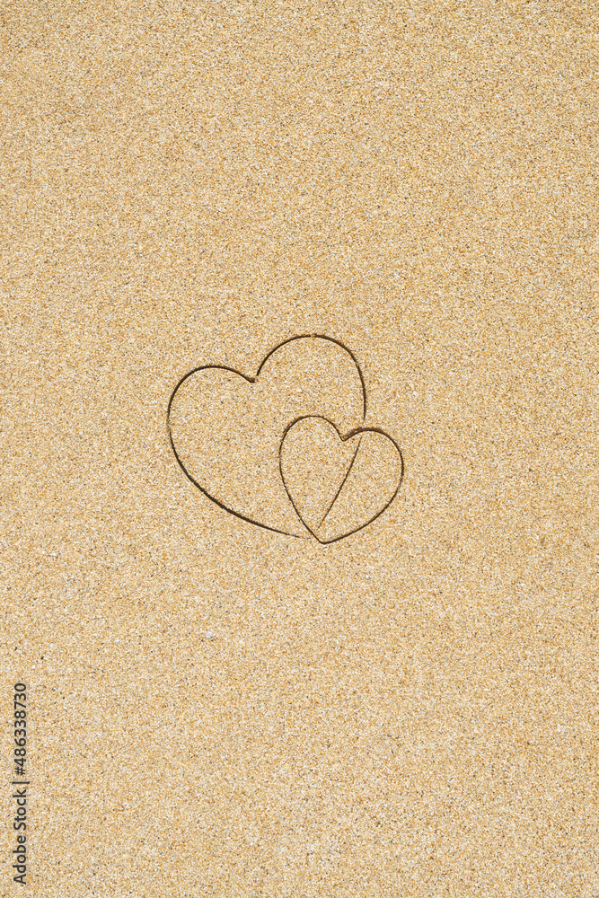 Hand-drawn shape of two heart on sand tropical beach. valentines day. Holiday concept. Creative, background, copy space, travel, summer. Flat lay Hand-drawn shape of two heart on sand tropical beach. valentines day. Holiday concept. Creative, background, copy space, travel, summer. Flat lay
