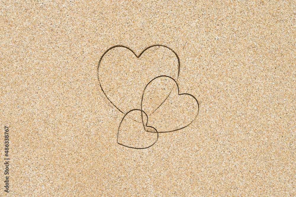 Hand-drawn shape of three heart on sand tropical beach. valentines day. Holiday, the vacation of family, friends concept. Creative, background, copy space, travel, summer. Flat lay Hand-drawn shape of three heart on sand tropical beach. valentines day. Holiday, the vacation of family, friends concept. Creative, background, copy space, travel, summer. Flat lay