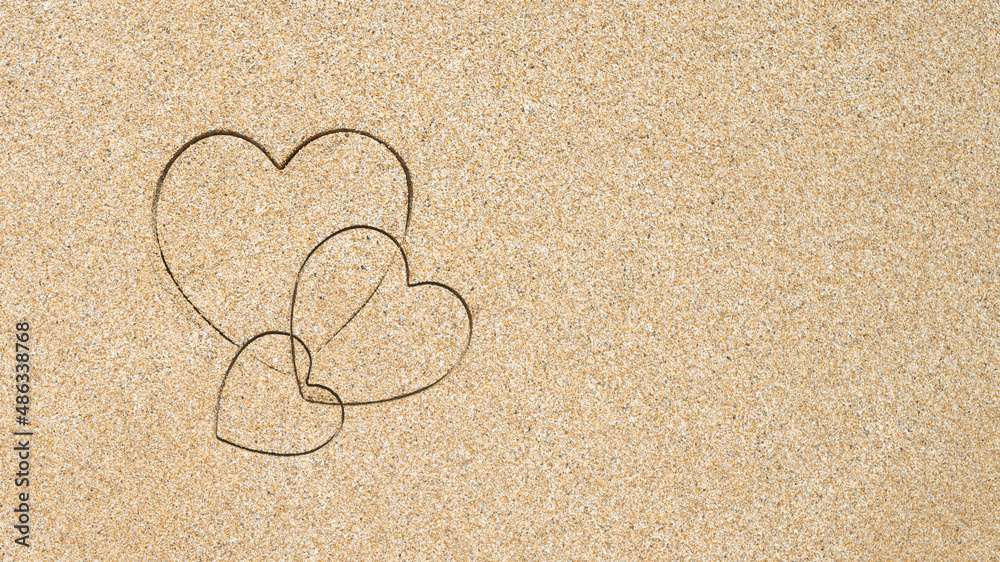 Hand-drawn shape of three heart on sand tropical beach. valentines day. Holiday, the vacation of family, friends concept. Creative, background, copy space, travel, summer. Flat lay