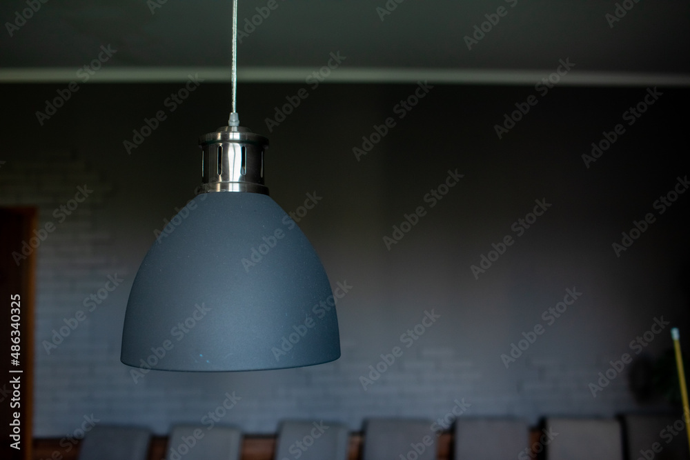 Obraz premium Close up of black stylish lamp hang over billiard table. Leisure activity interior design elements. selective focus