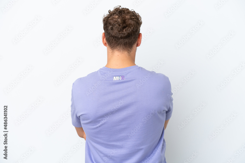 Young handsome caucasian man isolated on white background in back position Young handsome caucasian man isolated on white background in back position