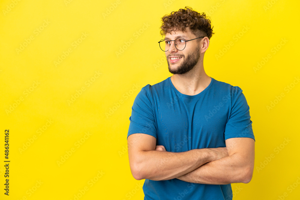 Young handsome caucasian man isolated on yellow background happy and smiling Young handsome caucasian man isolated on yellow background happy and smiling