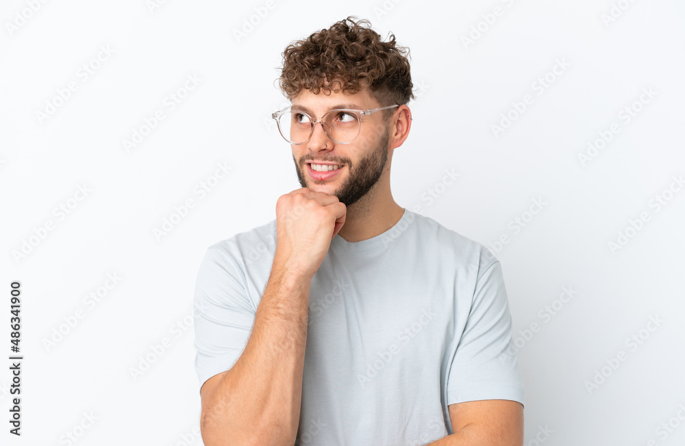 Young handsome caucasian man isolated on white background With glasses and thinking while looking up Young handsome caucasian man isolated on white background With glasses and thinking while looking up