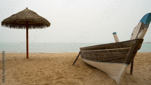 Fototapeta Naklejka Na Ścianę i Meble -  Family beach in the Wakrah souq (Traditional Market) along with traditional boats