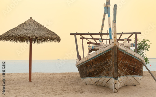 Family beach in the Wakrah souq (Traditional Market) along with traditional boats photo