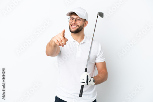 Handsome young man playing golf isolated on white background pointing front with happy expression
