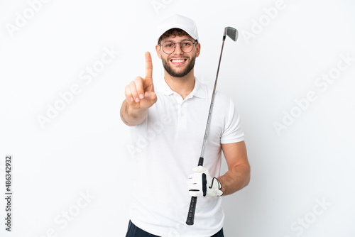 Handsome young man playing golf isolated on white background showing and lifting a finger