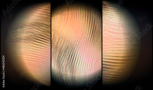 three fragments glowing sphere translucent through a striped texture on a dark background, blurred image, 3d rendering