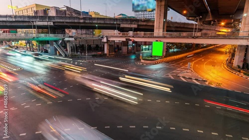 4K UHD time-lapse billboard with a green screen for advertising, busy crossroad with neon lights, timelapse of traffi car in Bangkok, Thailand, Urban transport lifestyle, Asian city life. High angle