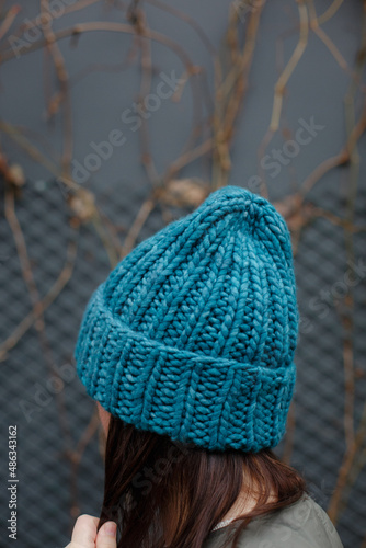  Handmade hat on a hipster girl. Hat in aquamarine or turquoise. A close-up shot of a hat made of natural wool / alpaca. Nice hat for the winter © Евгения Трастандецка