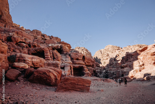 Ruins of the ancient city of Petra in Jordan. Red sandstone mountains on a clear day. Caves in the rock. Colorful photos.