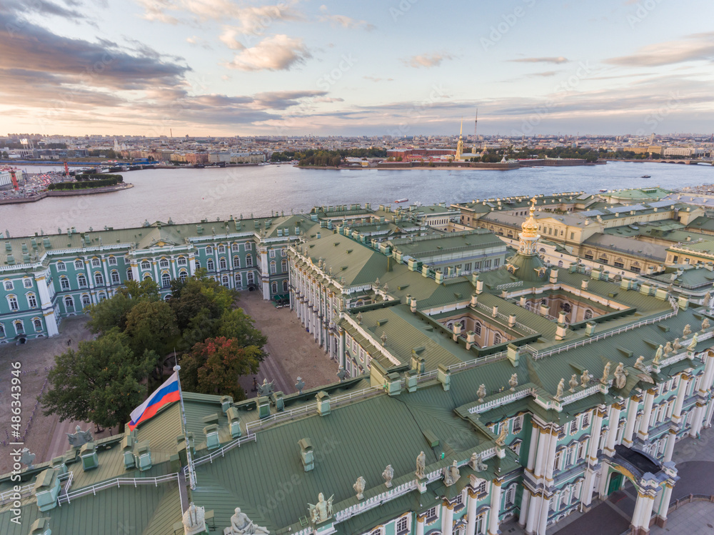 Russia, Saint-Petersburg, Aerial view of green Gables the Hermitage and roof top of Winter Palace at sunset, Russian flag, Neva river, Peter and Paul fortress, Rostral columns, old stock exchange