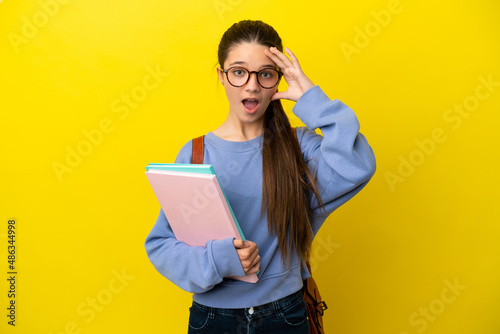Student kid woman over isolated yellow background with surprise expression
