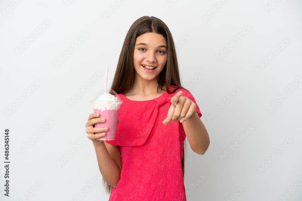 Little girl with strawberry milkshake over isolated white background surprised and pointing front Little girl with strawberry milkshake over isolated white background surprised and pointing front