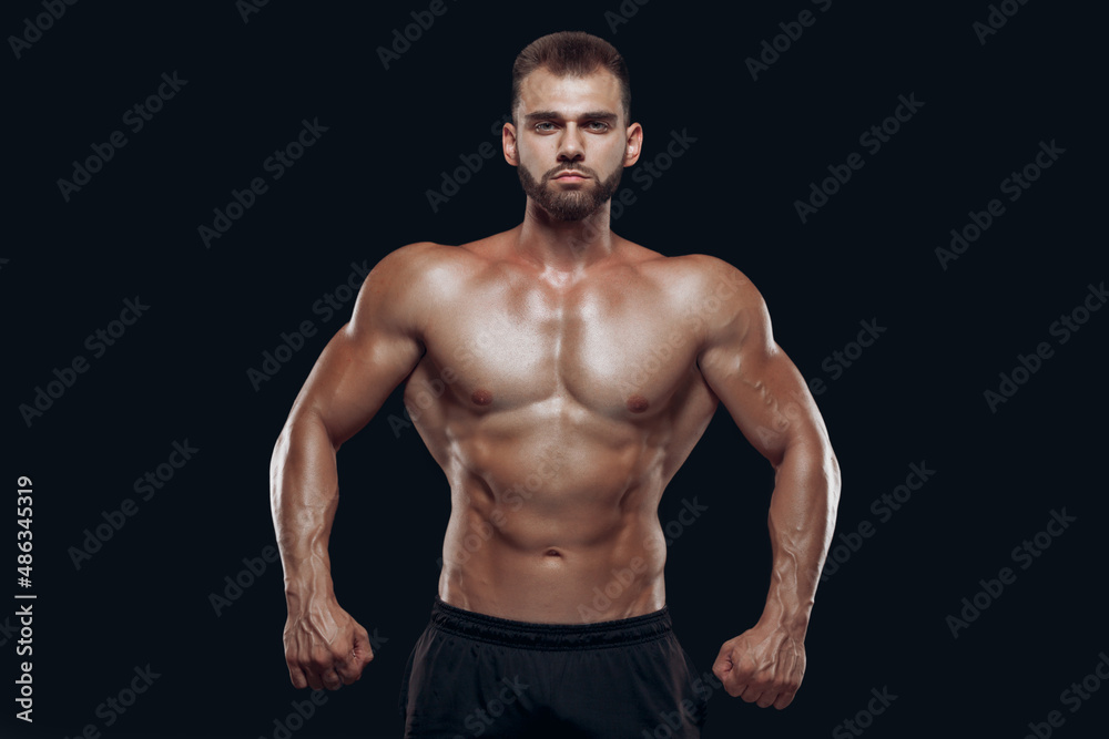 Sportive man workout with heavy weight disc. Photo of athletic young man with naked torso and good physique on white background. Strength and motivation