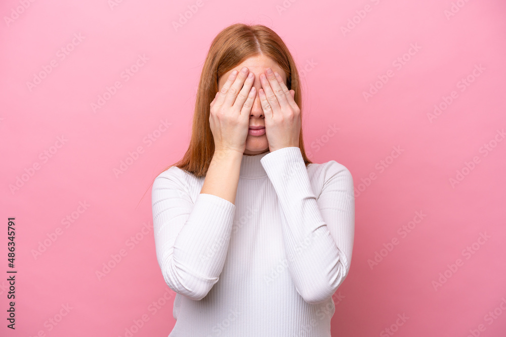 Young redhead woman isolated on pink background covering eyes by hands Young redhead woman isolated on pink background covering eyes by hands