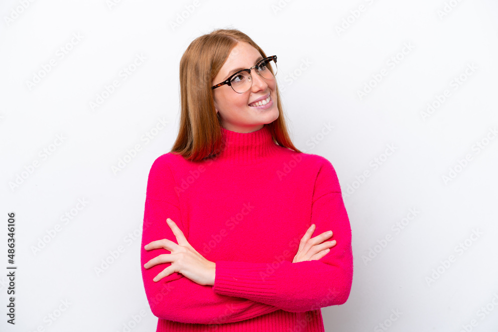 Young redhead woman isolated on white background looking up while smiling Young redhead woman isolated on white background looking up while smiling