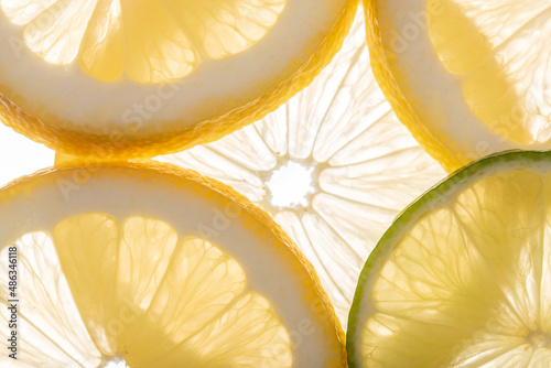Fresh juicy citrus fruits on white background, flat lay.