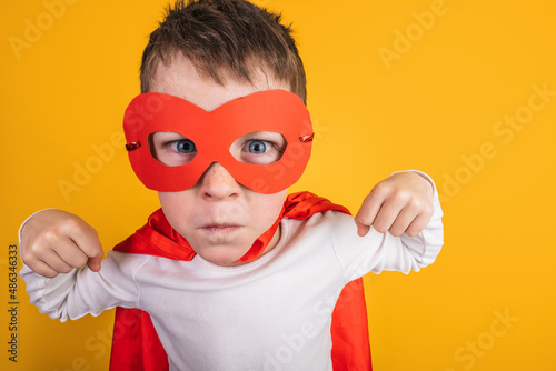 Boy in superhero outfit showing muscles photo