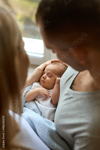 portrait of Unrecognizable parents holding their newborn baby