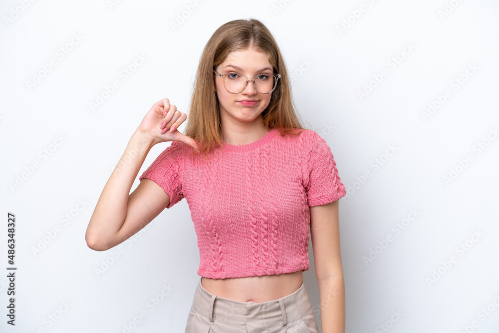 Teenager Russian girl isolated on white background showing thumb down with negative expression Teenager Russian girl isolated on white background showing thumb down with negative expression