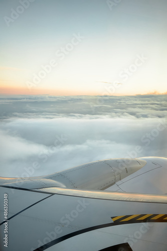 vertical image of cloudy sky at sunset from an airplane with copy space for travel advertising.