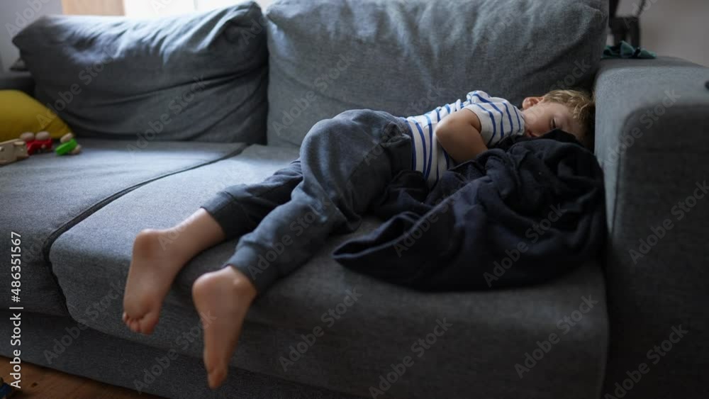 Child napping on couch in the afternoon Child napping on couch in the afternoon