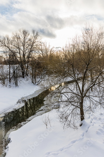 The Vokhonka river in winter in the historical center of the small district town of Pavlovsky Posad, Russia