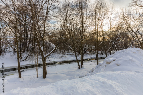 The Vokhonka river in winter in the historical center of the small district town of Pavlovsky Posad, Russia